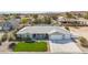Charming single-story home featuring a well-manicured lawn and a three-car garage at 1395 Logandale Dr, Logandale, NV 89021