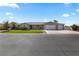 Traditional single-story home featuring a well-manicured lawn and a three-car garage at 1395 Logandale Dr, Logandale, NV 89021