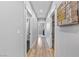 Hallway with hardwood floors and decorative sign, leading to other rooms at 1395 Logandale Dr, Logandale, NV 89021