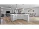 Open-concept kitchen with large island, stainless appliances, and seamless flow to the dining area at 1395 Logandale Dr, Logandale, NV 89021
