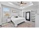 Bright main bedroom featuring tray ceiling, ceiling fan, carpet floors, and a window with view at 1395 Logandale Dr, Logandale, NV 89021