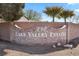 The Lake Valley Estates brick entrance sign framed by desert landscaping adds exclusivity to the community at 1395 Logandale Dr, Logandale, NV 89021