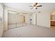 Light and bright bedroom with mirrored closet doors, ceiling fan and tile flooring visible in ensuite at 1851 Hillpointe Rd # 2412, Henderson, NV 89074