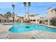 Inviting community pool with lounge chairs and a rock feature at 1851 Hillpointe Rd # 2412, Henderson, NV 89074