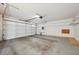 Spacious two car garage with storage shelving, garage door opener, and a clean floor at 1851 Hillpointe Rd # 2412, Henderson, NV 89074