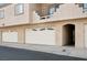 Garage with white doors in a multi-story stucco building at 1851 Hillpointe Rd # 2412, Henderson, NV 89074