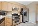 Well-equipped kitchen featuring stainless steel appliances and wooden cabinets at 1851 Hillpointe Rd # 2412, Henderson, NV 89074
