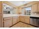 Kitchen view with wooden cabinets, white countertops, and stainless steel dishwasher at 1851 Hillpointe Rd # 2412, Henderson, NV 89074