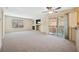 Bright and airy living room with fireplace, ceiling fan, and sliding door to balcony at 1851 Hillpointe Rd # 2412, Henderson, NV 89074