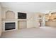 Open living room features a fireplace, ceiling fan, television and sliding glass door to patio at 1851 Hillpointe Rd # 2412, Henderson, NV 89074