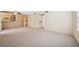Spacious living room with neutral carpet, ceiling fan and pass through to the kitchen at 1851 Hillpointe Rd # 2412, Henderson, NV 89074