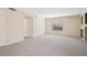 Open concept living room with neutral carpet and a fireplace at 1851 Hillpointe Rd # 2412, Henderson, NV 89074