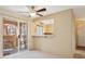 Cozy living room with sliding door access to the balcony and a kitchen view at 1851 Hillpointe Rd # 2412, Henderson, NV 89074
