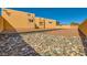 A lovely backyard featuring rocks and boulders in the landscape and a stucco wall adding privacy at 2201 Rosanna St, Las Vegas, NV 89117