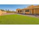 The backyard features an expansive lawn and covered patio, perfect for outdoor entertaining at 2201 Rosanna St, Las Vegas, NV 89117
