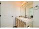 Well-lit bathroom featuring a single sink vanity, tiled countertop, and a neutral color scheme at 2201 Rosanna St, Las Vegas, NV 89117