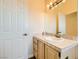 Bathroom with tiled countertop, updated lighting, and white door at 2201 Rosanna St, Las Vegas, NV 89117