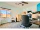 Bright bedroom with work station, ceiling fan, and large window at 2201 Rosanna St, Las Vegas, NV 89117