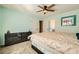 Inviting bedroom with a comfortable bed, ceiling fan, and view of en suite bathroom and closet at 2201 Rosanna St, Las Vegas, NV 89117