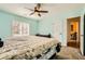 Comfortable bedroom featuring a ceiling fan, and view through to bathroom and hall at 2201 Rosanna St, Las Vegas, NV 89117
