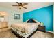 Comfortable bedroom with a spacious bed, ceiling fan, and a view into the en suite bathroom at 2201 Rosanna St, Las Vegas, NV 89117