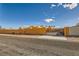 A vibrant stucco home with a gated driveway and secure perimeter walls offering privacy and security at 2201 Rosanna St, Las Vegas, NV 89117
