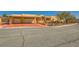 Desert home with a colorful driveway and two-car garage with stone pillar accents at 2201 Rosanna St, Las Vegas, NV 89117