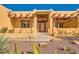 Inviting front entrance with desert landscaping, stone walkway, and detailed trim at 2201 Rosanna St, Las Vegas, NV 89117
