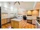 Well-lit kitchen with tile counters, modern appliances, and open layout to living area at 2201 Rosanna St, Las Vegas, NV 89117
