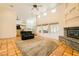 Inviting living room with fireplace, tile flooring, and seamless flow to adjacent kitchen at 2201 Rosanna St, Las Vegas, NV 89117