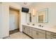 Main bathroom with double sinks, a modern vanity, and a tv at 2201 Rosanna St, Las Vegas, NV 89117