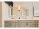Contemporary main bathroom featuring double vanity sinks and modern light fixtures at 2201 Rosanna St, Las Vegas, NV 89117