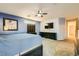 Main bedroom with blue walls, custom bed, tv, and natural light at 2201 Rosanna St, Las Vegas, NV 89117