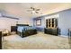 Expansive main bedroom with custom bed frame, blue accent walls, and neutral carpet at 2201 Rosanna St, Las Vegas, NV 89117