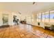Bright sun room with tiled floor, bicycle, and floor to ceiling windows at 2201 Rosanna St, Las Vegas, NV 89117