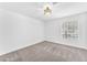 Bedroom features neutral carpet, a window, and modern lighting at 2606 S Durango Dr # 287, Las Vegas, NV 89117