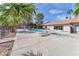 Community pool with lounge chairs surrounded by lush palm trees and a clubhouse for relaxation at 2606 S Durango Dr # 287, Las Vegas, NV 89117
