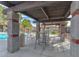 Covered poolside seating area with tables and chairs, perfect for lounging by the pool at 2606 S Durango Dr # 287, Las Vegas, NV 89117