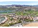 Aerial view of a residential community with golf course and lake in a mountainous desert landscape at 30 Strada Di Villaggio # 409, Henderson, NV 89011
