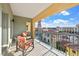 Relaxing balcony with wrought iron railing, seating, and neighborhood views at 30 Strada Di Villaggio # 409, Henderson, NV 89011