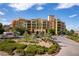 Multi-story building surrounded by desert landscaping, with a moving truck visible at 30 Strada Di Villaggio # 409, Henderson, NV 89011