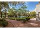 Charming courtyard with lush landscaping, brick pathway and view of the community pool at 30 Strada Di Villaggio # 409, Henderson, NV 89011
