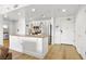 Charming kitchen featuring white cabinets, stainless steel appliances, and a granite-topped kitchen island at 30 Strada Di Villaggio # 409, Henderson, NV 89011