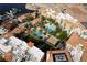 Aerial view of community pool surrounded by lush landscaping and buildings with terracotta roofs at 30 Strada Di Villaggio # 409, Henderson, NV 89011