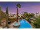 Aerial view of a backyard showcasing a pool, spa, mature palm trees and well-kept landscaping at 3024 Half Shell Way, Las Vegas, NV 89128