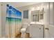 Bathroom with a tub, shower, white vanity, and a beach-themed shower curtain at 3024 Half Shell Way, Las Vegas, NV 89128