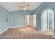 Bedroom with a ceiling fan, an archway to the bath, and natural light from the window at 3024 Half Shell Way, Las Vegas, NV 89128