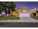 Charming two-story home featuring manicured landscaping, a spacious two-car garage, and desert style xeriscaping at 3024 Half Shell Way, Las Vegas, NV 89128