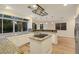 Bright kitchen features granite countertops, stainless appliances, white cabinetry, and center island with cooktop at 3024 Half Shell Way, Las Vegas, NV 89128