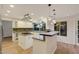 Bright kitchen with granite countertops, white cabinets, pendant lighting, and stainless steel appliances at 3024 Half Shell Way, Las Vegas, NV 89128